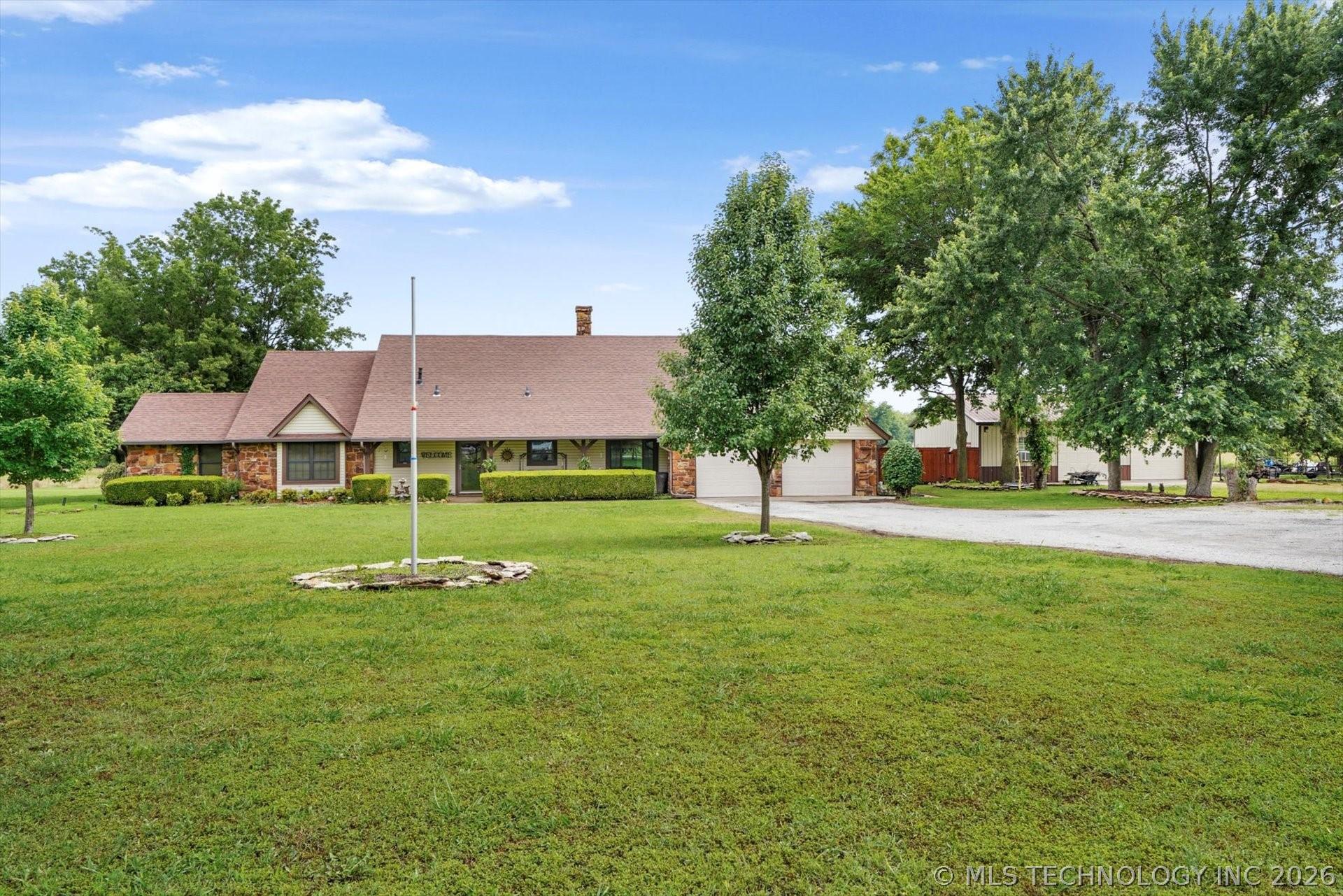 Image 1: Home sits off the road towards the middle of the p