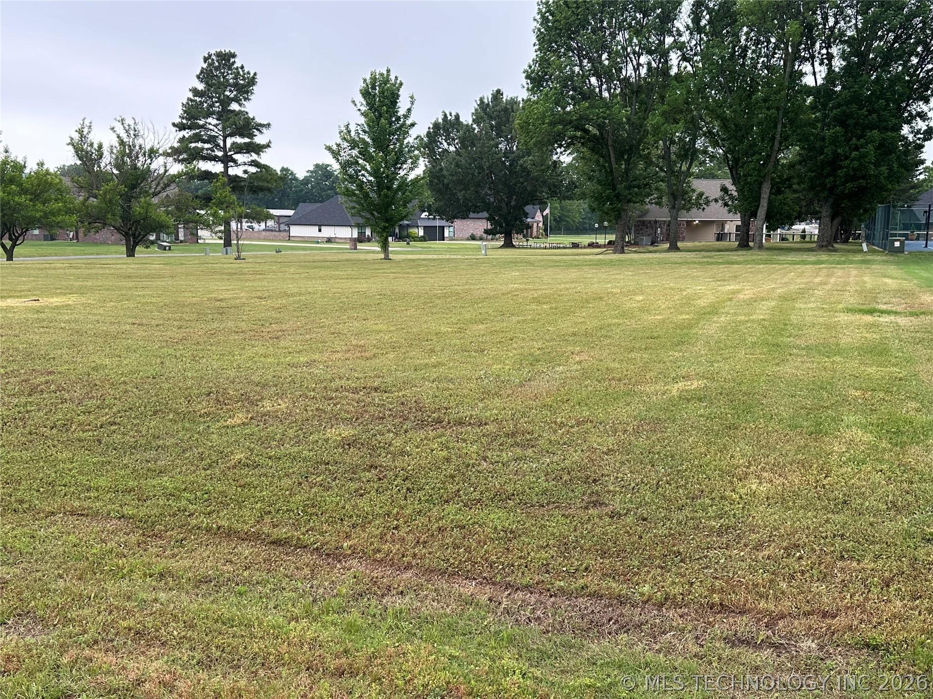 Image 1: Expansive grassy area with mature deciduous and ev