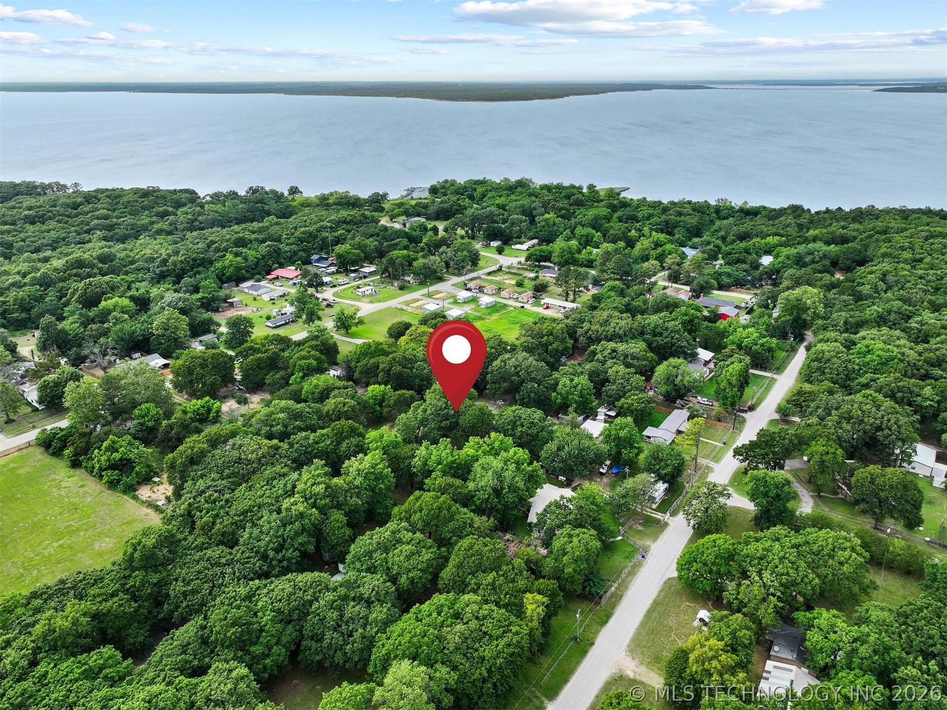 Image 1: Expansive lot with mature trees, offering a serene