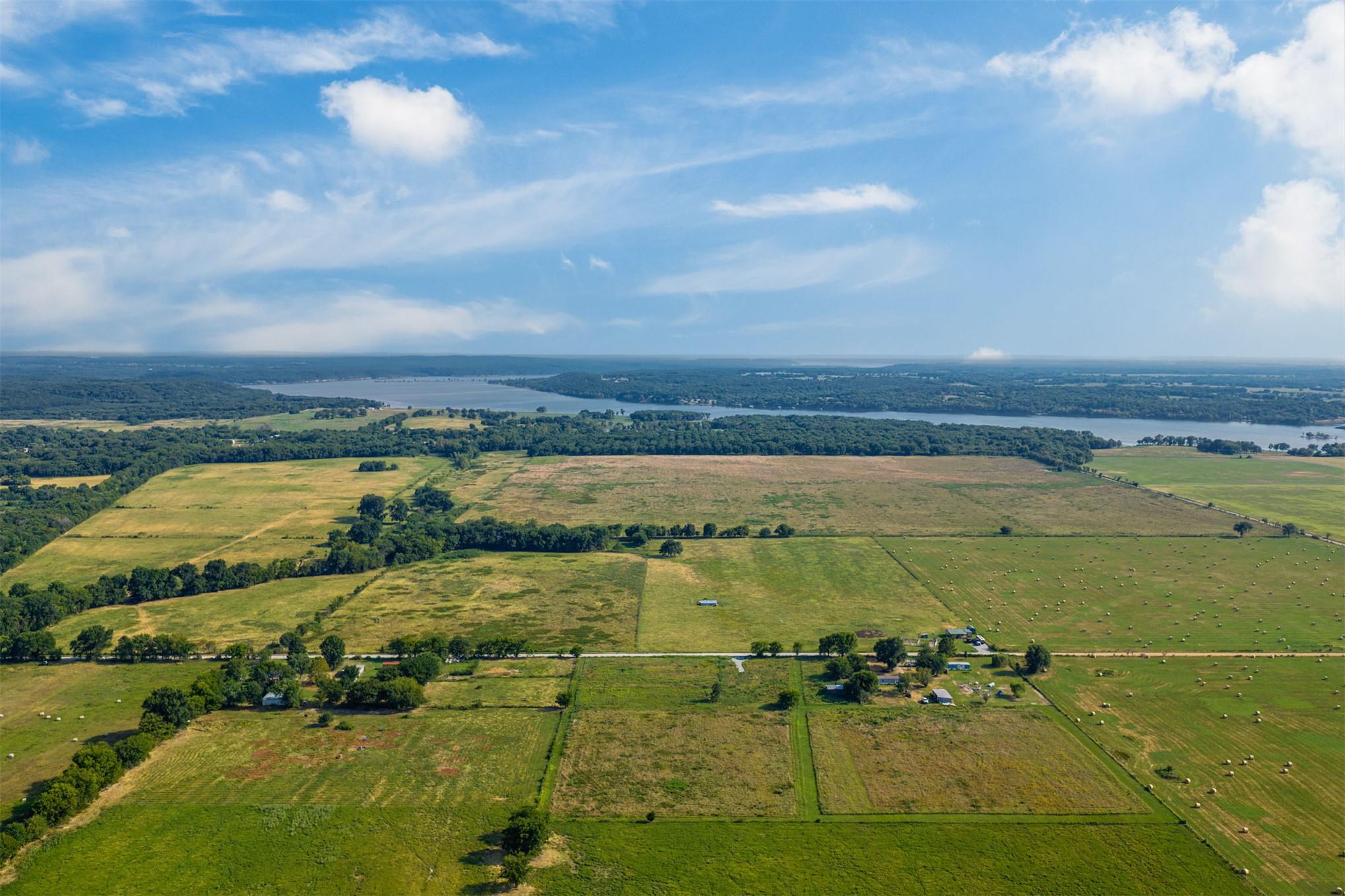 Image 2: Green fields with distant water frontage
