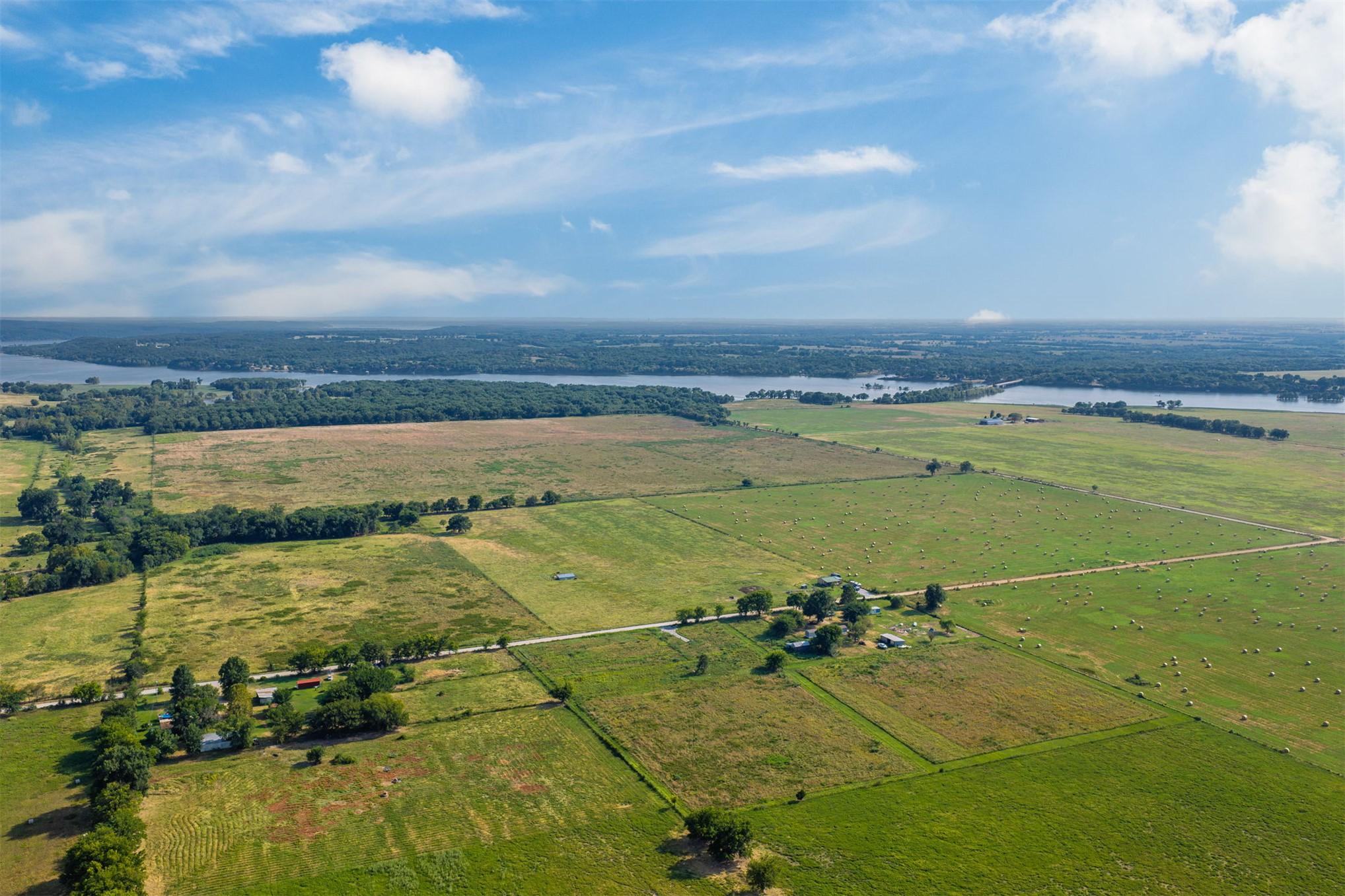 Image 3: Open fields with scattered mature trees and distan