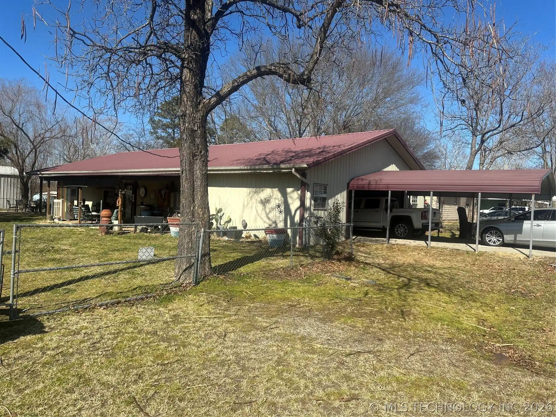Image 1: BACK YARD AND GARAGE & CARPORT OF HOME