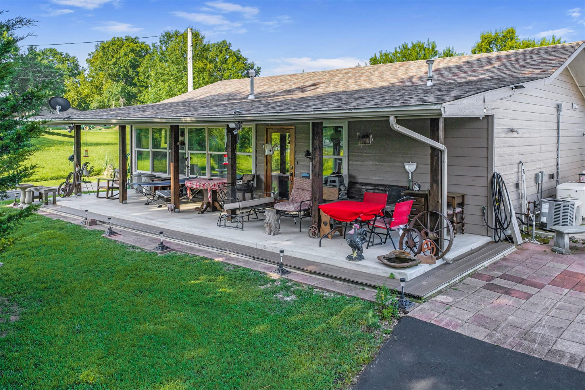 Image 1: Expansive concrete with side patio and space for R