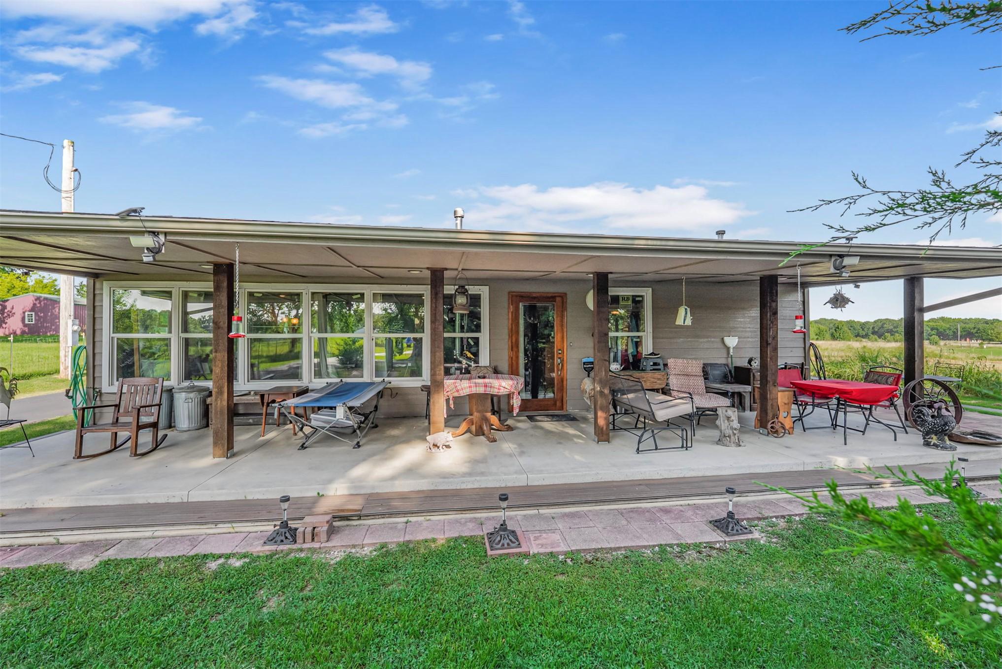 Image 4: Spacious front porch featuring multiple windows al