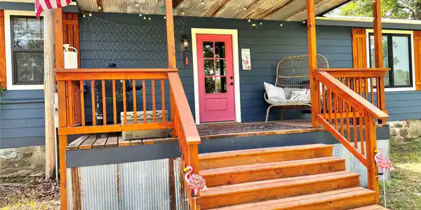 Image 3: Inviting front porch with natural wood stairs and