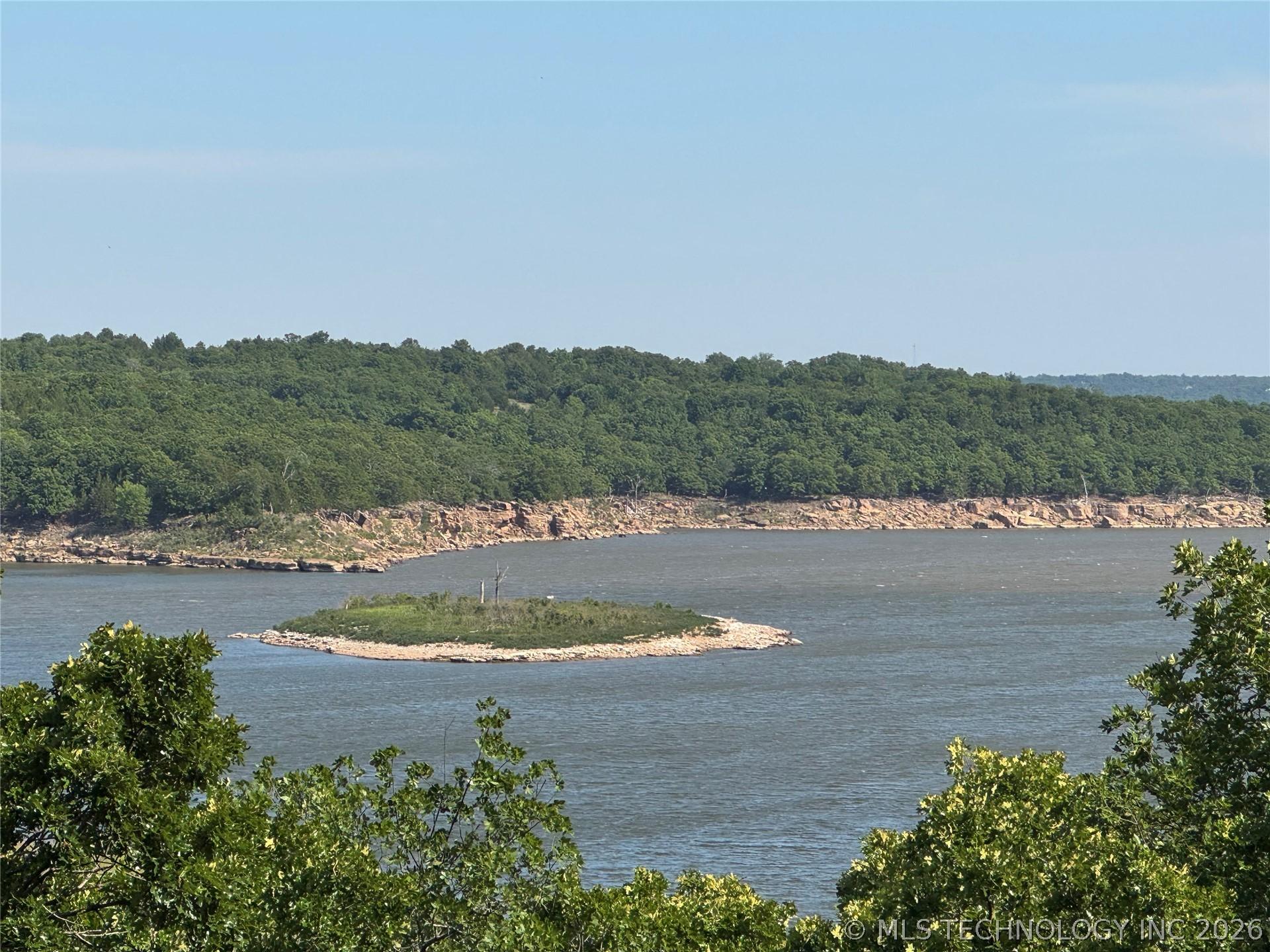Image 2: Expansive water frontage with a distant wooded sho