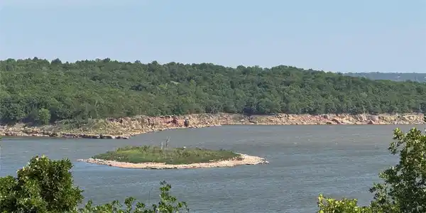 Image 2: Expansive water frontage with a distant wooded sho