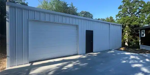 Image 4: Metal-sided outbuilding featuring a large roll-up