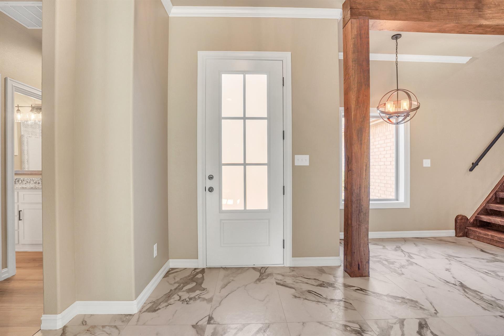 Image 3: Foyer featuring large-format marble-look tile floo