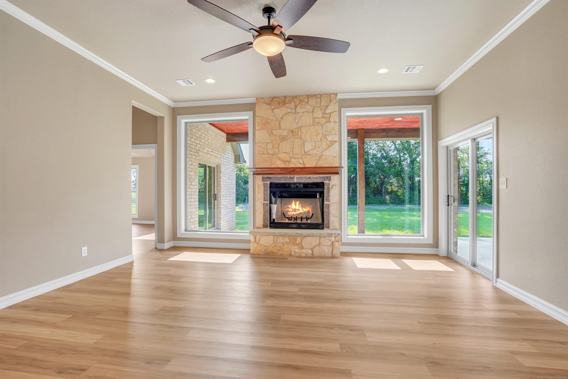 Image 4: Spacious living area featuring light wood-finish f