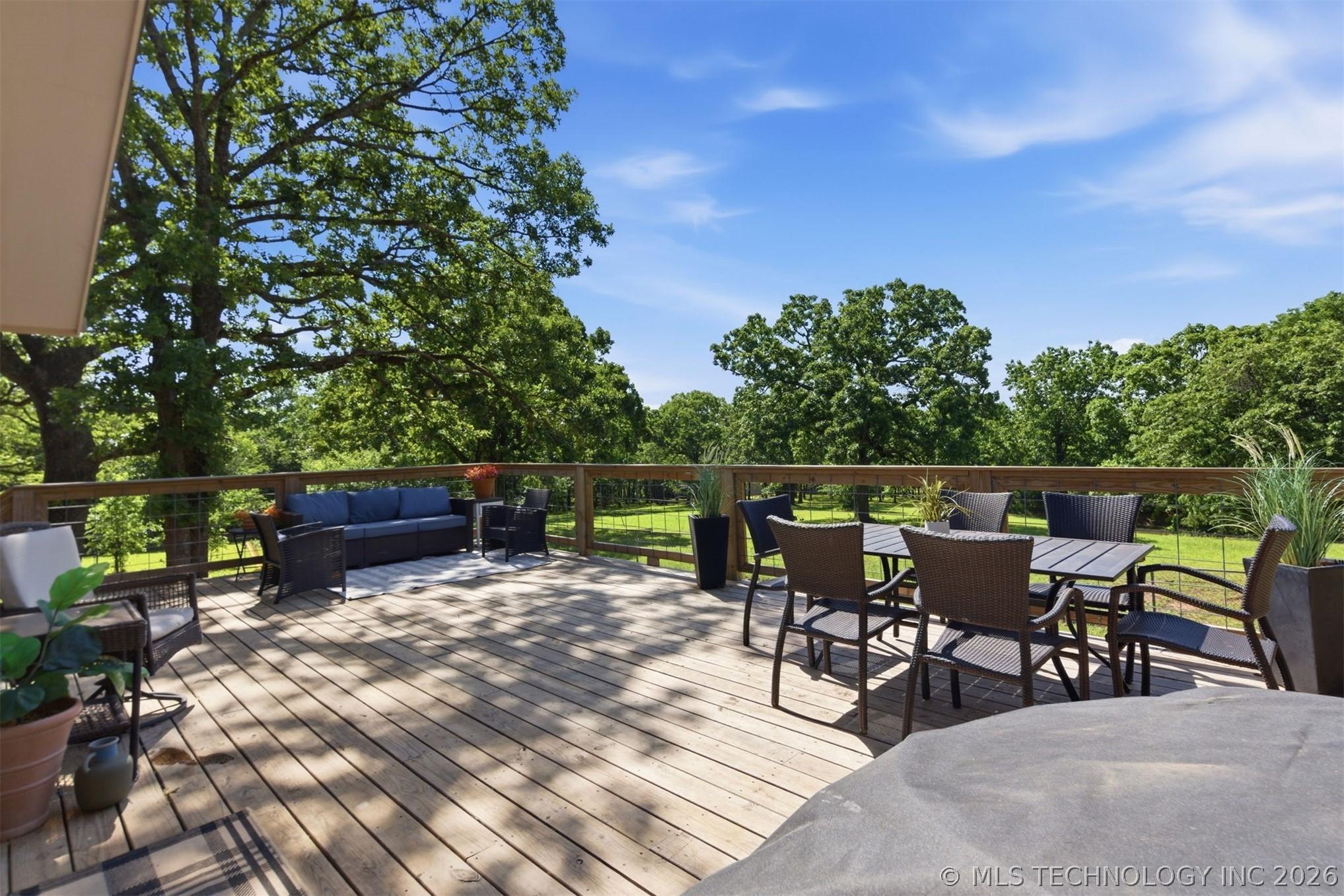 Image 3: Expansive wood deck with natural wood railing over