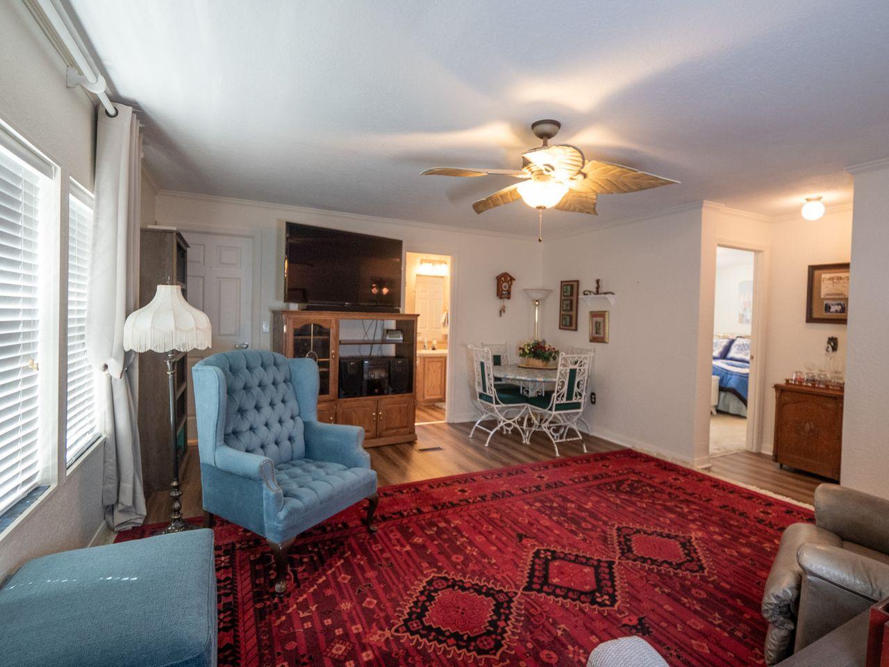Image 4: Spacious living area featuring wood-finish floorin