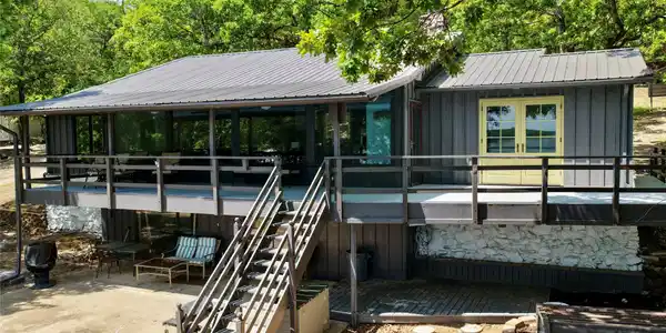 Image 2: Raised residence featuring a metal roof, expansive