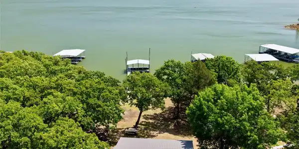 Image 4: Waterfront property featuring extensive tree cover