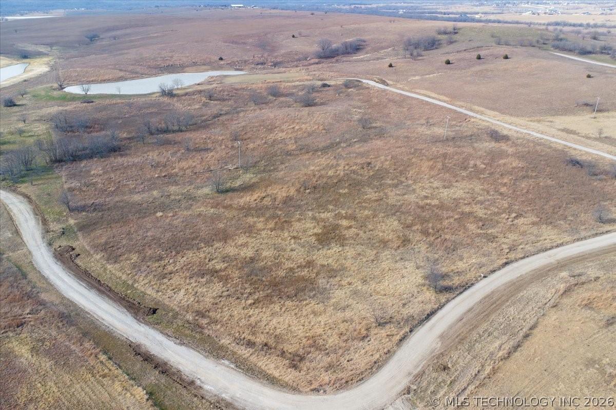 Image 1: Expansive, undeveloped land featuring two visible