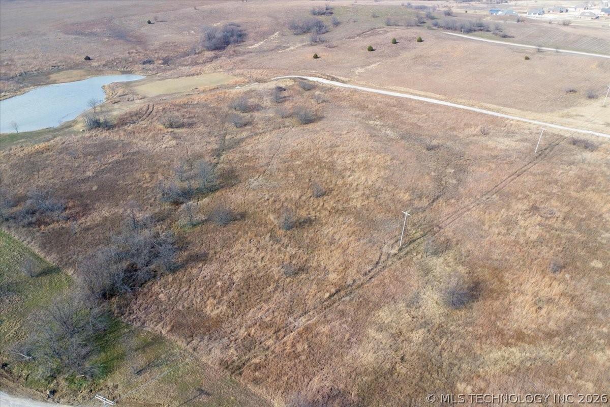 Image 4: Expansive rural acreage featuring a natural pond,