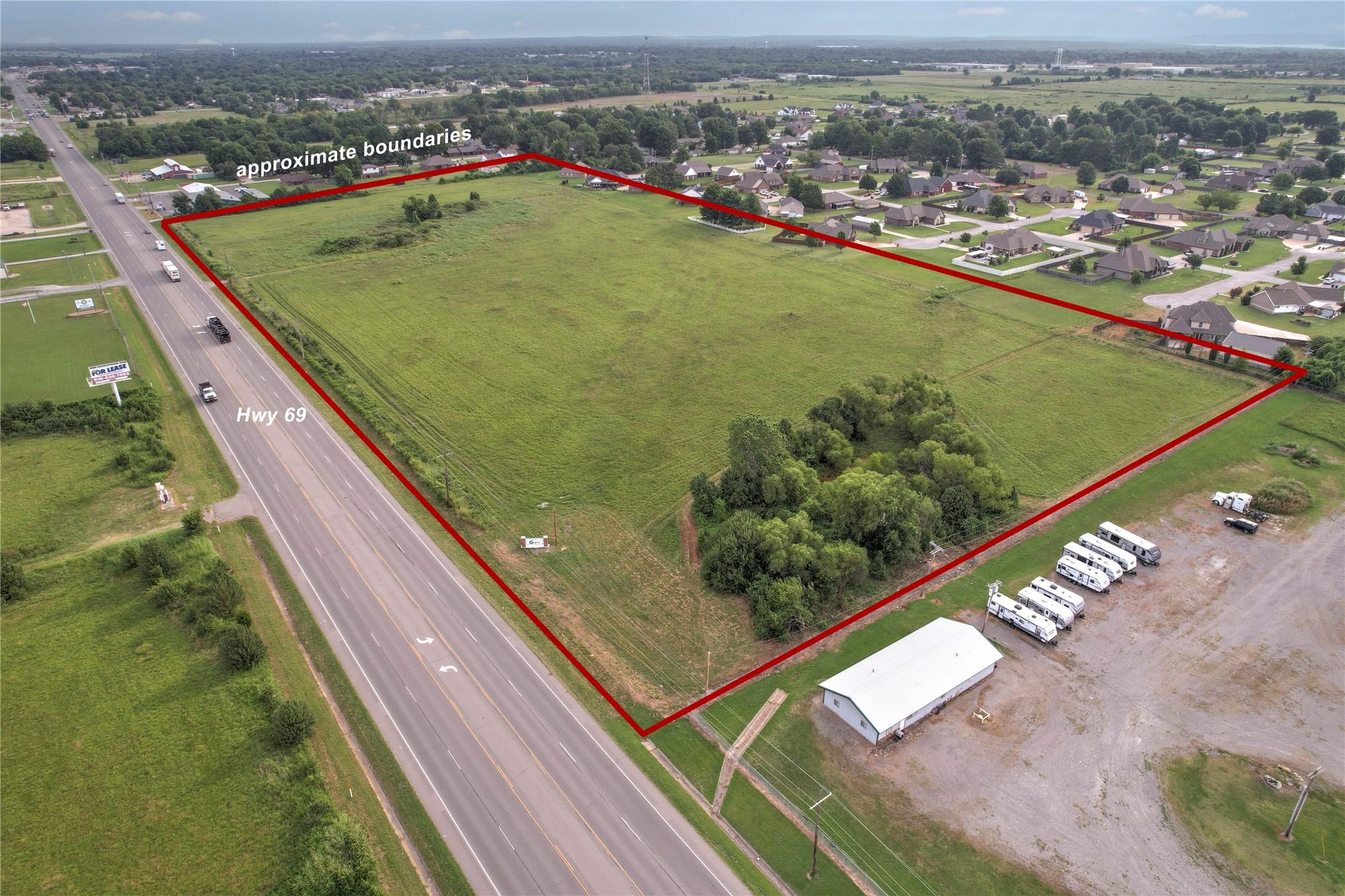 Image 1: Expansive undeveloped land featuring a cleared fie