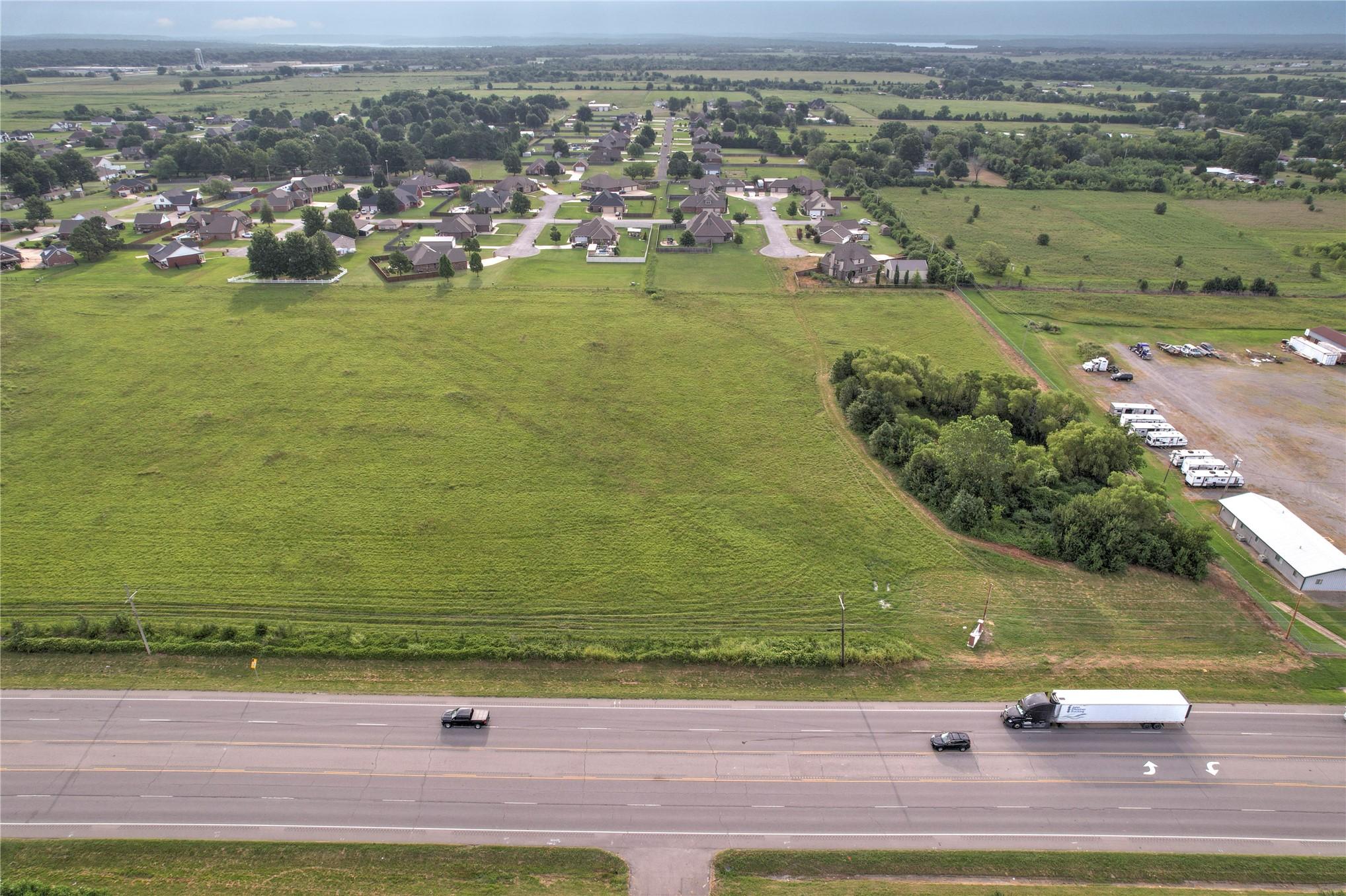 Image 2: Expansive green field with established residential