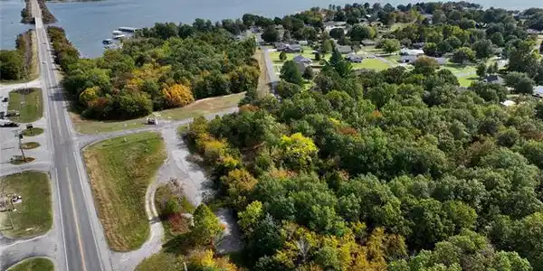 Image 3: Expansive lot featuring mature trees and partial c