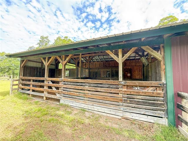 Image 4: Open-sided barn structure featuring wood framing a