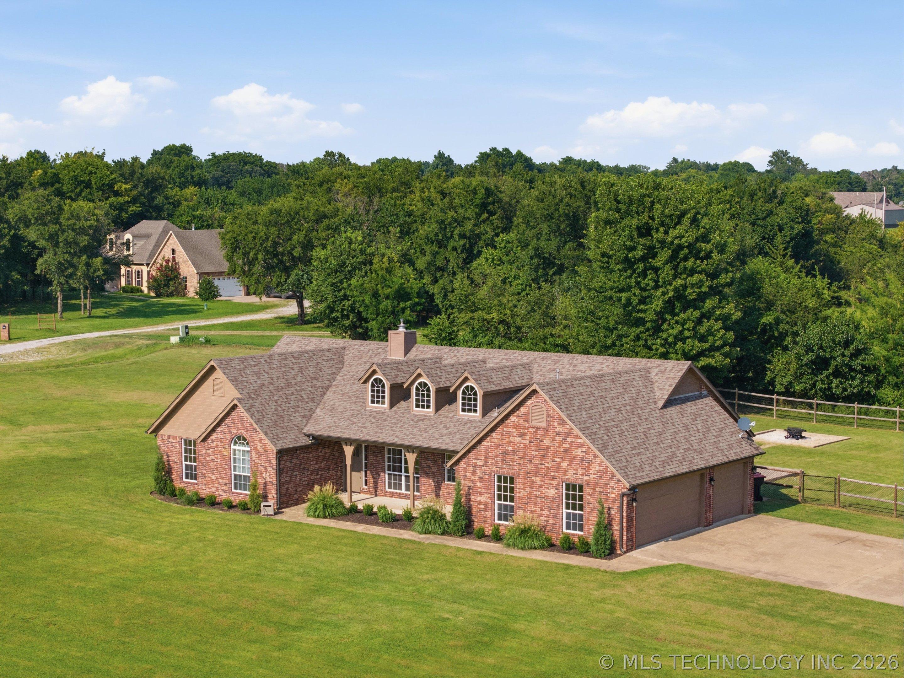 Image 2: Brick exterior with a shingle roof and dormer wind