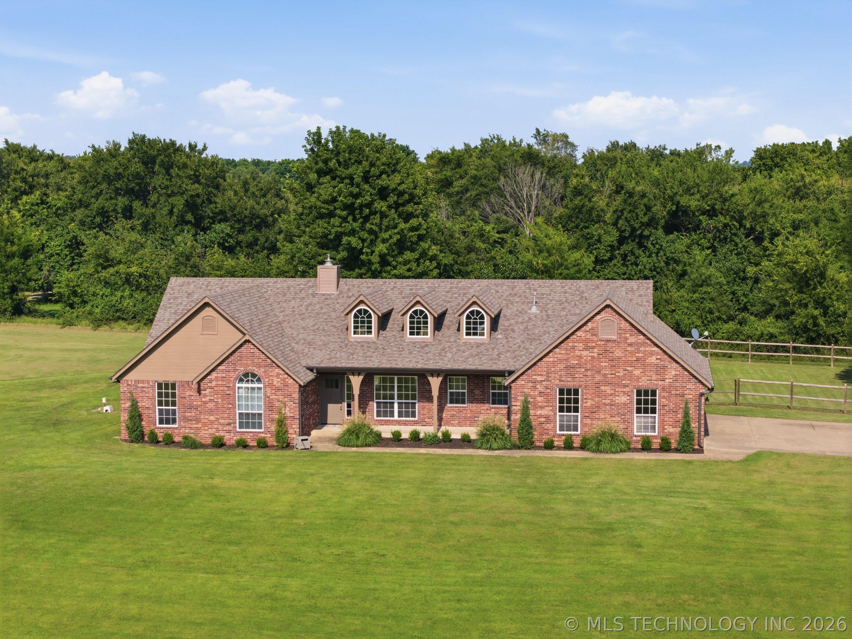 Image 3: Brick exterior with a gabled roof and multiple dor