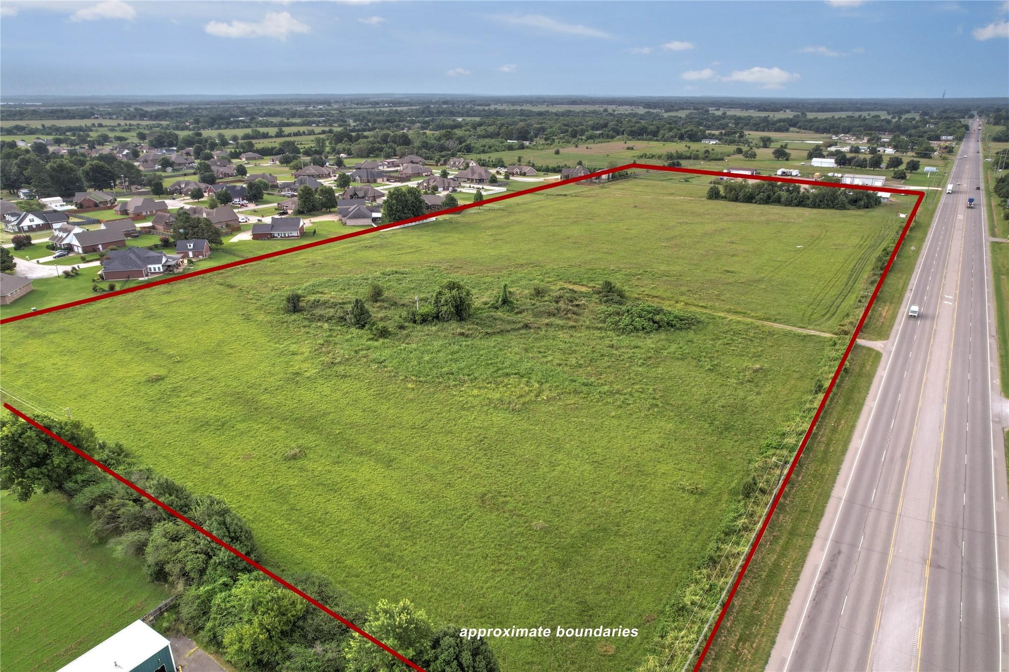 Image 4: Expansive land parcel featuring open green fields