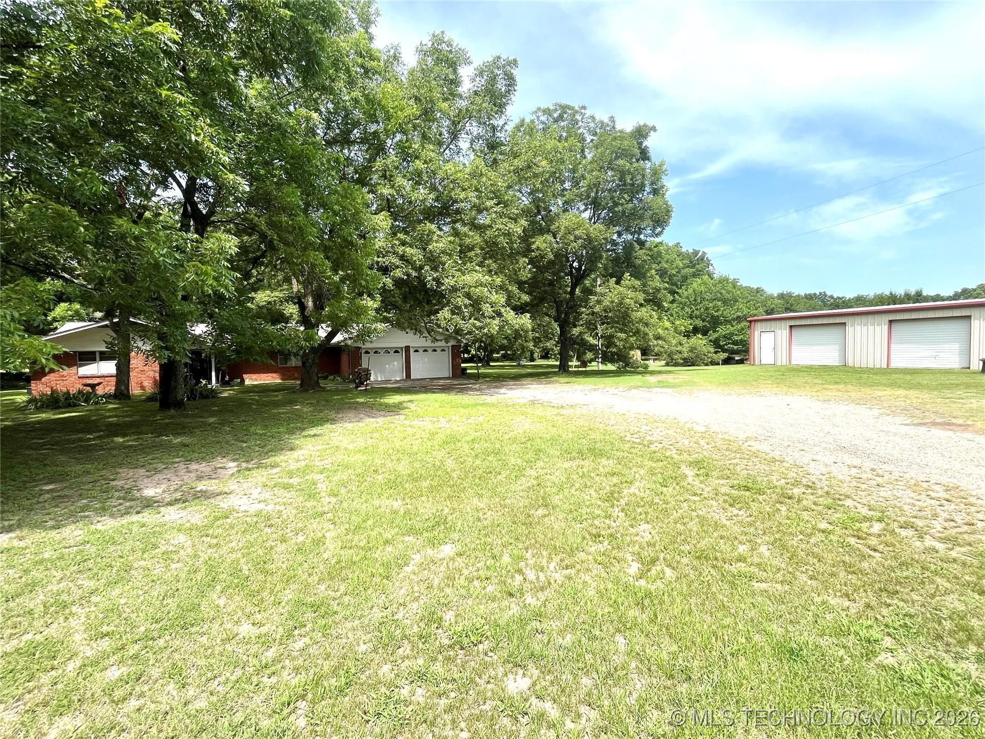 Image 2: Full view of home with shop building