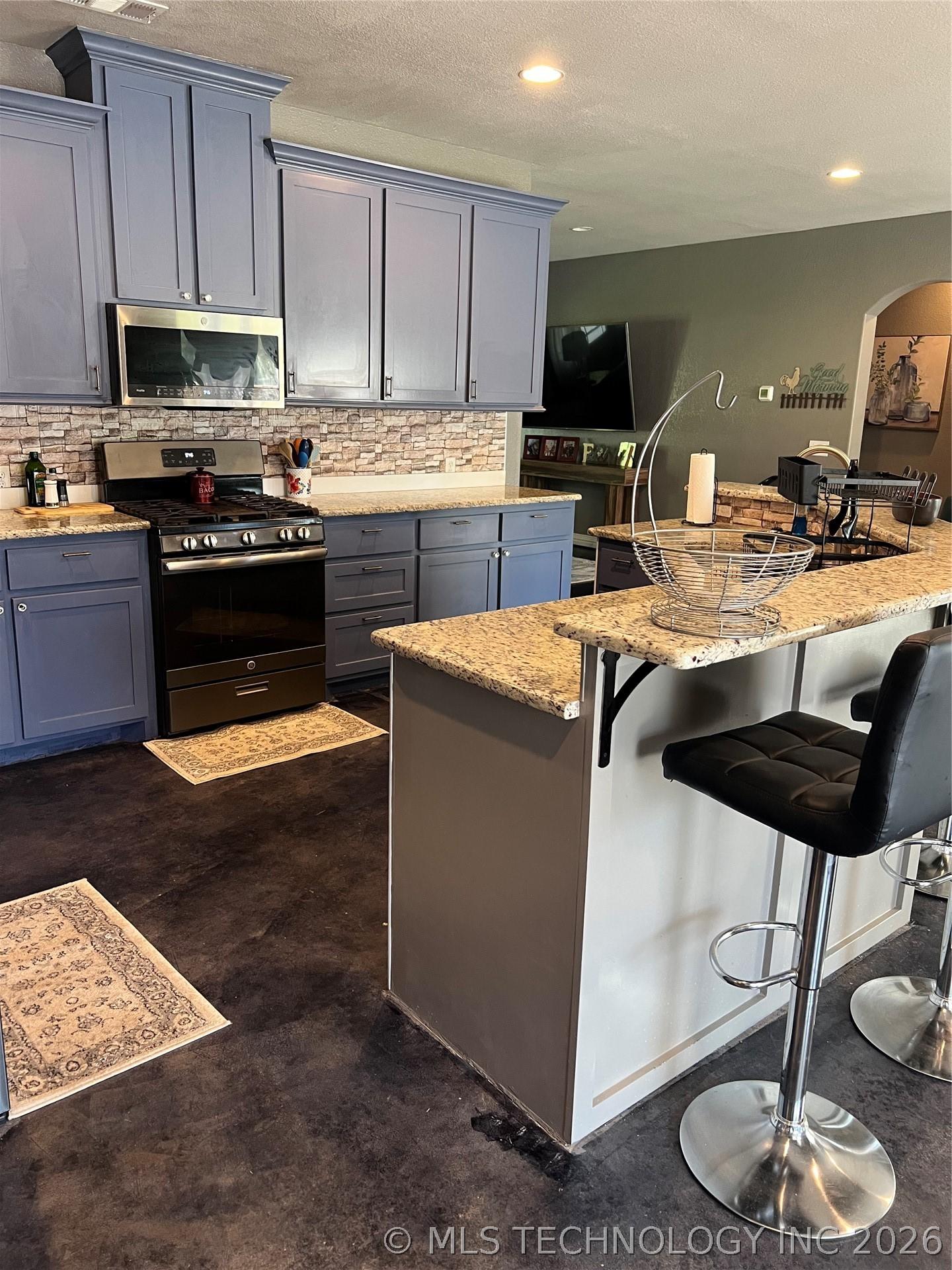 Image 3: Open kitchen and breakfast bar.