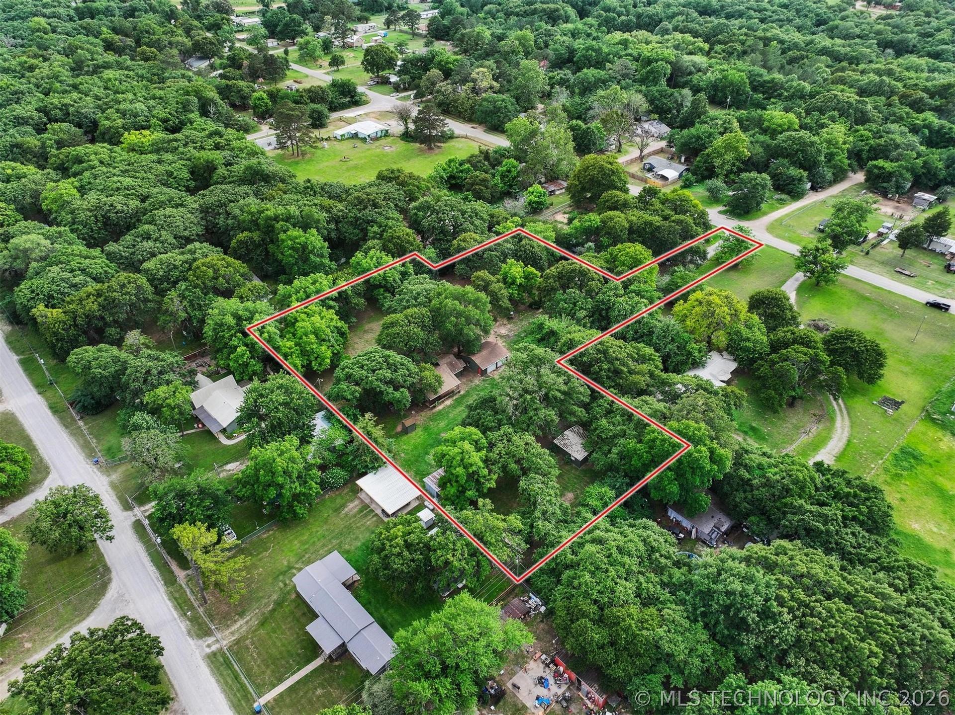 Image 3: Expansive treed lot featuring multiple structures