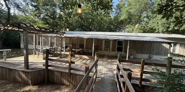 Image 4: Expansive wooden deck with a built-in pergola, fea