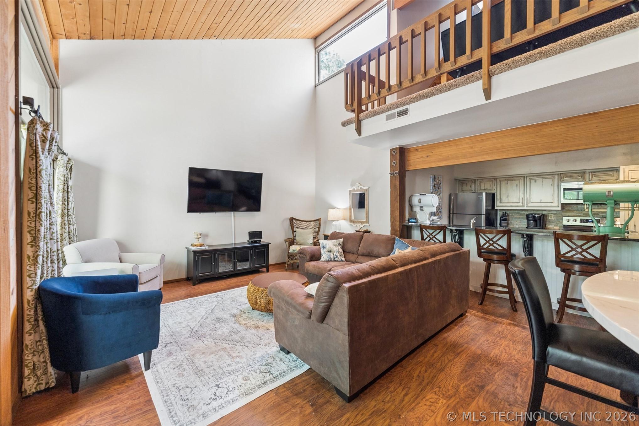 Image 3: Open-concept living space featuring wood-finish fl