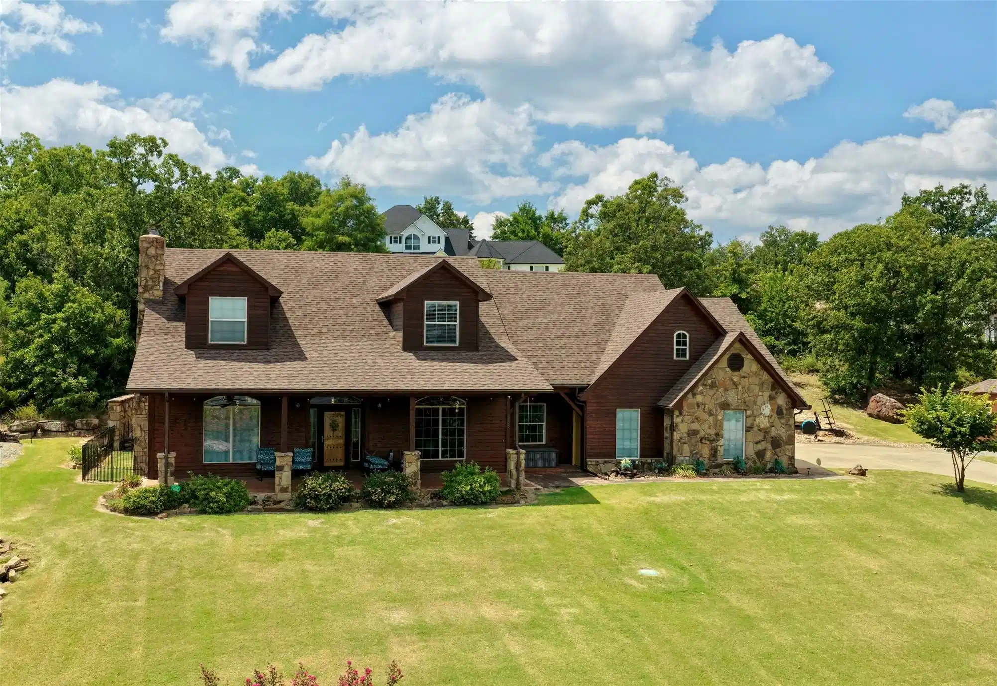 Image 1: Exterior featuring stone accents, a covered front