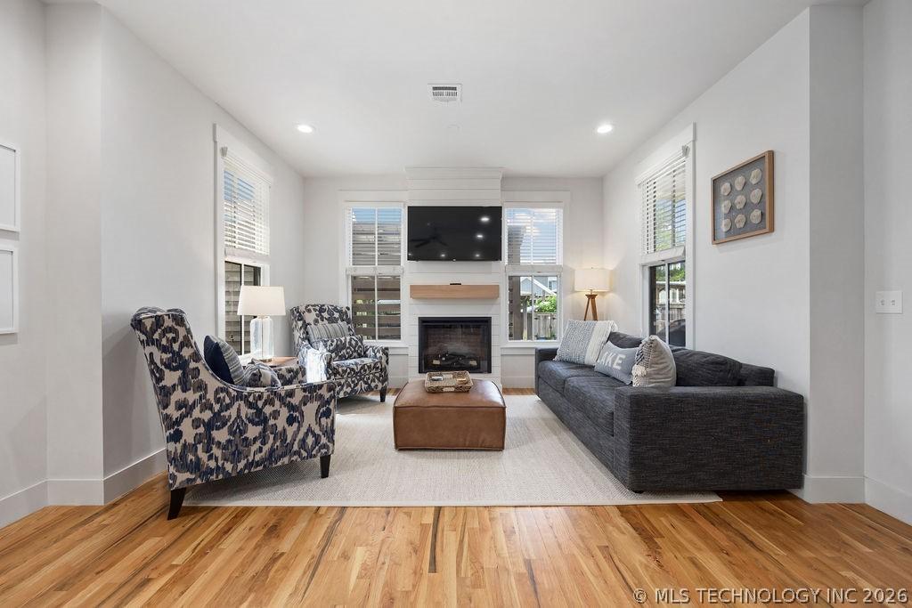Image 3: Living room with wood finished floors, baseboards,