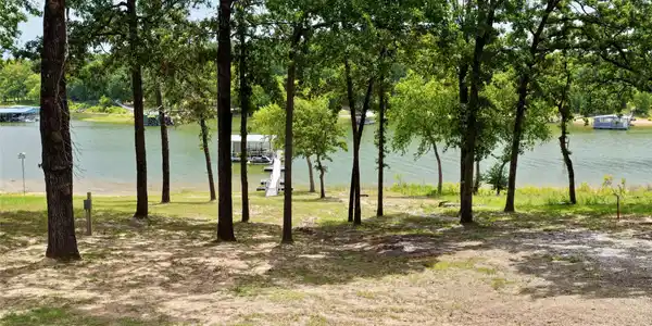 Image 3: Wooded lot with lake frontage and a private dock s