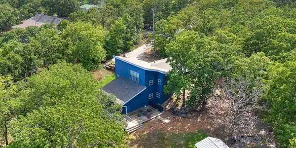 Image 2: Blue exterior structure with a dark shingled roof