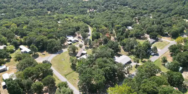 Image 2: Aerial view showcasing this lakefront property nes