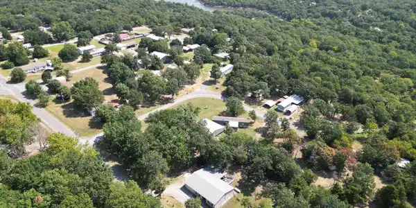 Image 3: Aerial view showcasing this residential property n