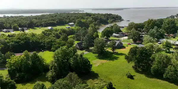 Image 2: Expansive waterfront property featuring mature tre