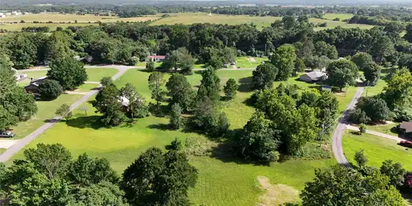 Image 3: Expansive green landscapes with mature trees and p