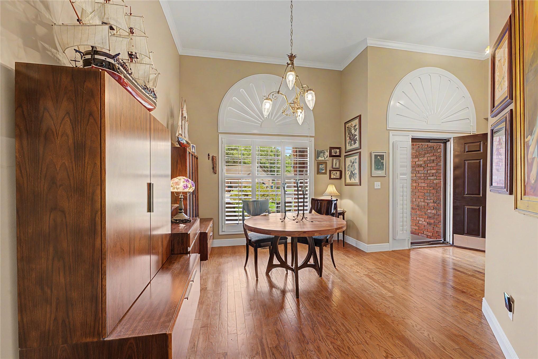 Image 4: Foyer with hardwood flooring, high ceilings, and c