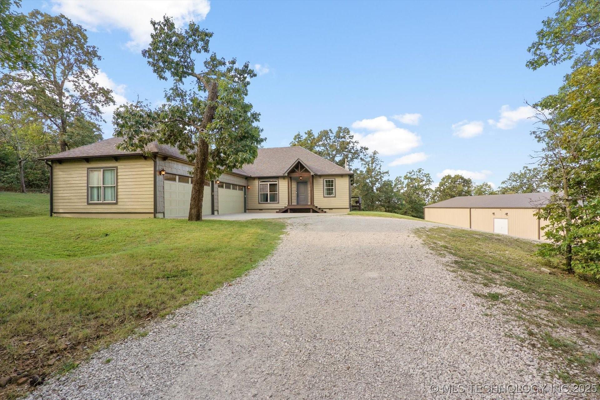 Image 2: Front view of home showcasing manicured landscapin