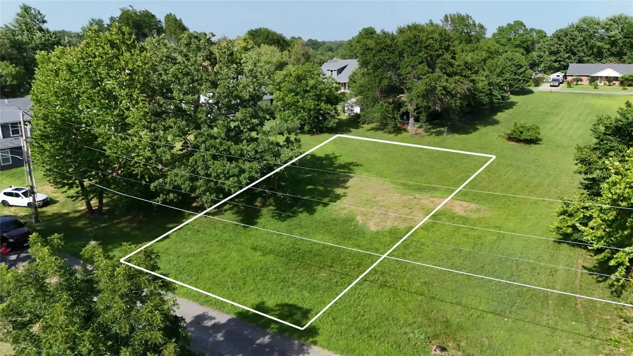 Image 1: Expansive green lot featuring mature perimeter tre