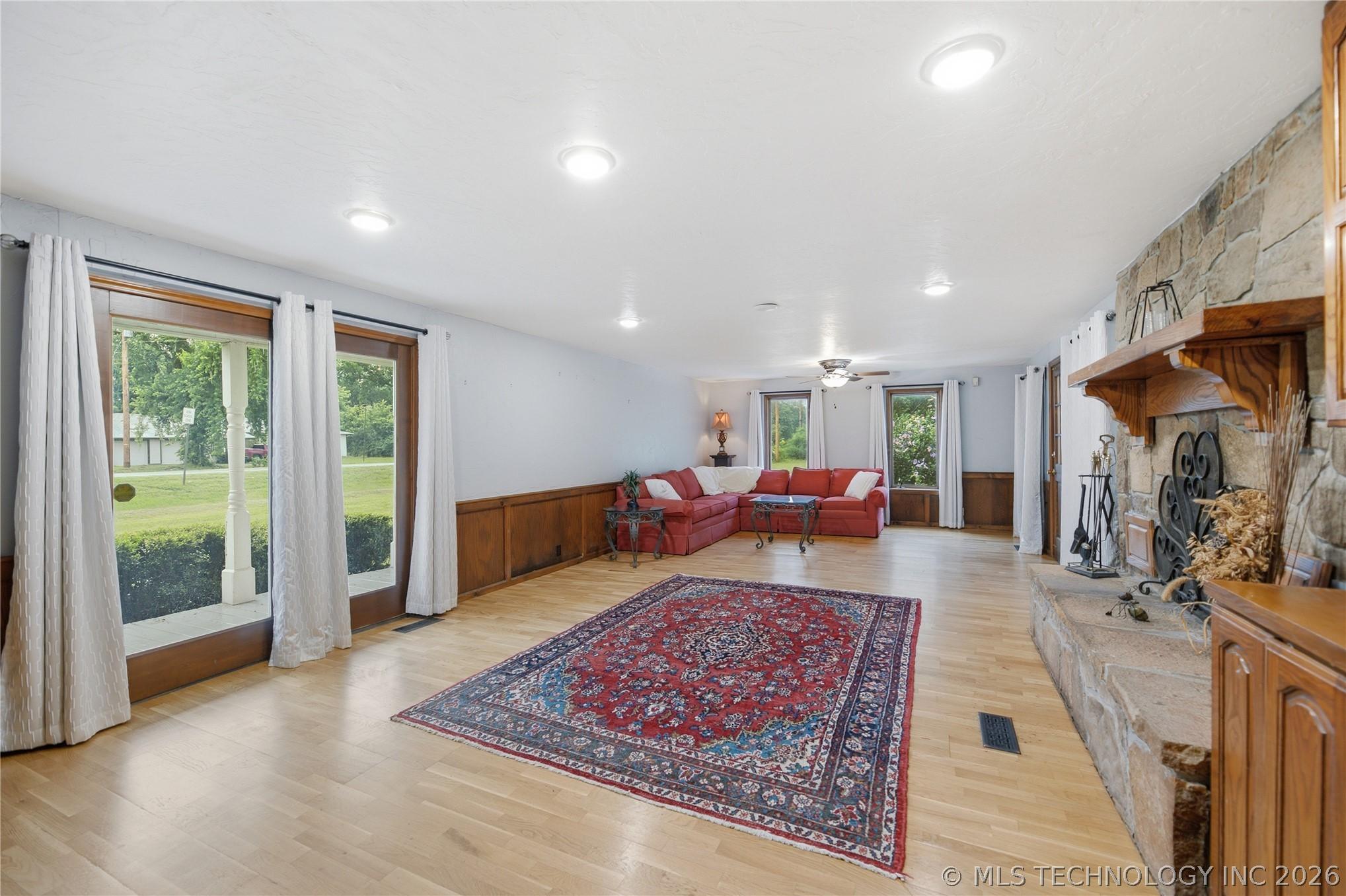 Image 3: Expansive family room with hardwood floors & abund