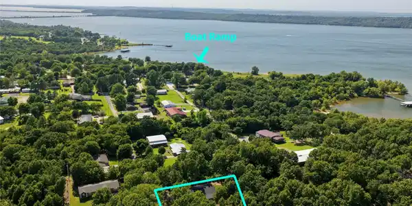 Image 2: Aerial perspective showcasing a property surrounde