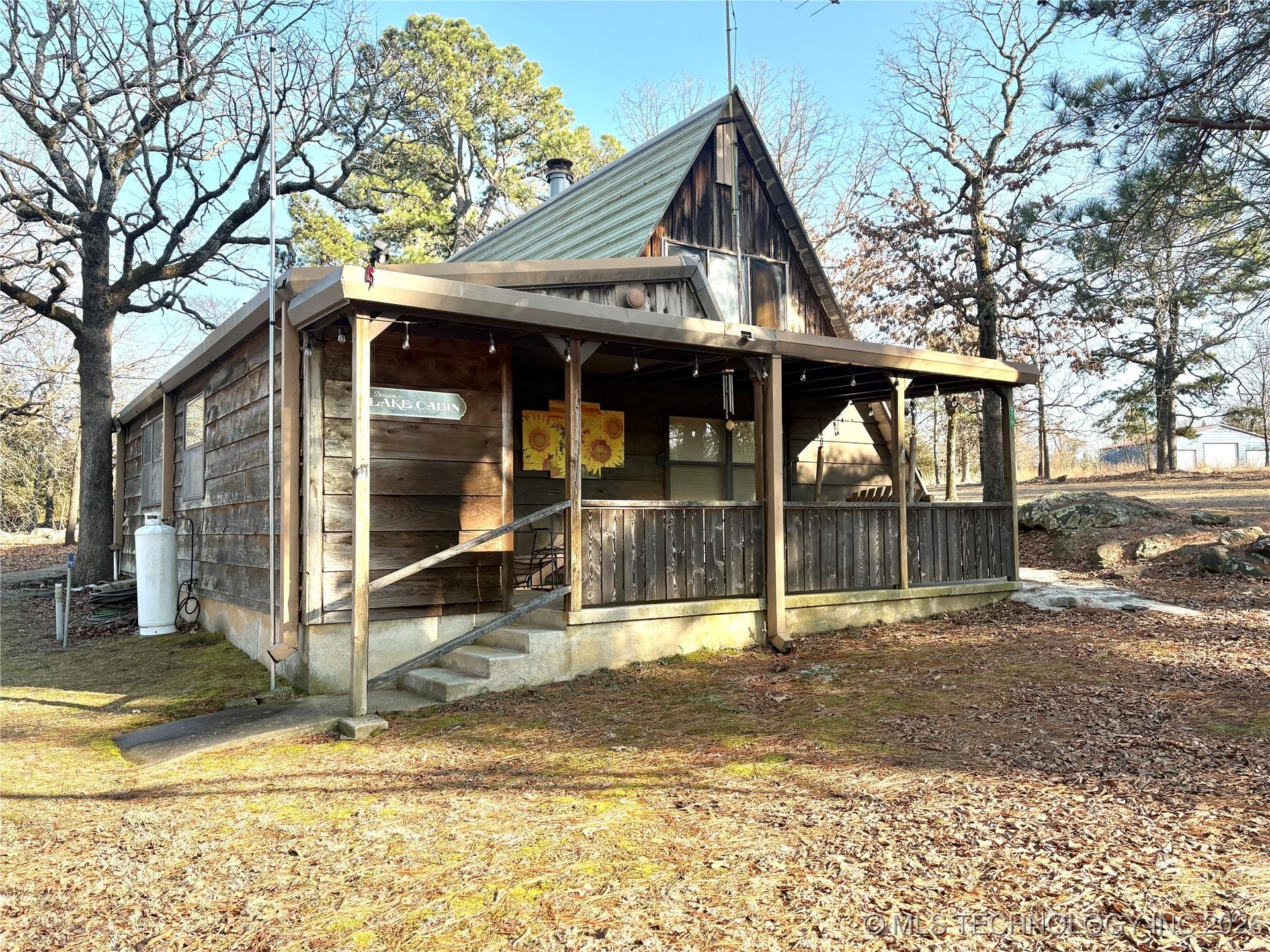 Image 2: Front view of home with covered porch