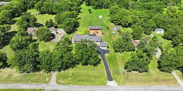 Image 3: Expansive property featuring multiple structures,