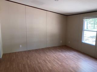 Image 3: Wood-finish flooring with neutral wall panels and