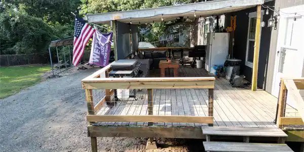 Image 2: Spacious wood deck with wire railing, covered outd