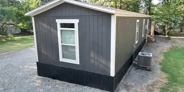 Image 3: Exterior featuring vertical panel siding, white wi